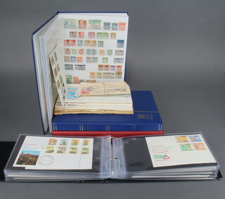 An album of mint and used Rhodesian stamps 1937-1974, a blue stock book of mint Rhodesian stamps, blue ditto of mint and used world stamps - Australia, Denmark, Helvetia and an an album of GB and Rhodesian first day covers 
