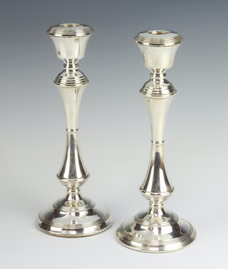 A pair of silver concave stem vase shaped candlesticks Birmingham 1975, 25cm 