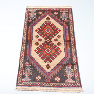 A brown and blue ground belouche rug with diamond shaped medallion to the centre 150cm x 85cm 