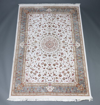 A white and green ground North West Persian floral patterned silk rug with central medallion within a multi row border 223cm x 147cm  