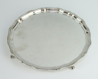 A silver salver with pie crust rim on claw and ball feet Birmingham 1965, 25cm, 484 grams