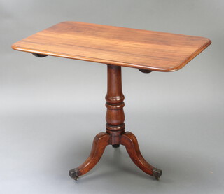 A Georgian rectangular mahogany snap top wine table, raised on a gun barrel column with tripod base ending in brass caps and casters 74cm h x 90cm w x 56cm d  