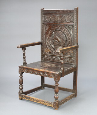 A Victorian carved oak Wainscot chair constructed of old timber, the back carved a portrait bust of a gentleman, raised on turned supports with box framed stretcher 227cm h x 69cm w x 54cm d (seat 45cm x 39cm) 