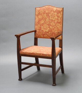 An Edwardian Art Nouveau oak show frame open arm chair the seat and back upholstered in floral material raised on square supports 115cm h x 61cm w x 50cm d (seat 34cm x 30cm) 