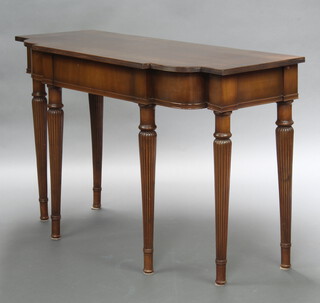 A Georgian style crossbanded mahogany side/serving table fitted a drawer, raised on turned and reeded supports 86cm h x 140cm w x 54cm d 