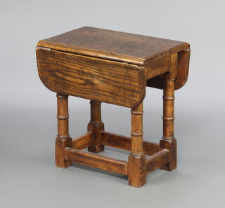 A 17th Century style oak drop flap table, raised on turned and block supports with box frame stretcher 48cm h x 46cm w x 30cm when closed x 61cm when open 