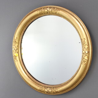 A 19th Century concave mirror contained in a decorative gilt frame 51cm diam. 