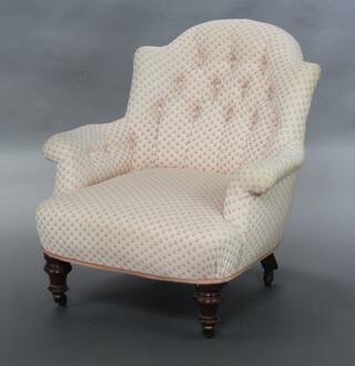 A Victorian metal framed armchair upholstered in white and pink floral buttoned material, raised on turned supports 77cm h x 74cm w x 60cm d (seat 37cm x 41cm)