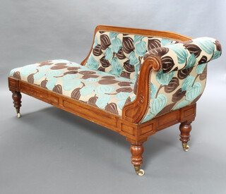 A William IV mahogany show frame chaise longue upholstered in floral material, raised on turned supports 90cm h x 200cm w x 61cm d (seat 150cm w x 47cm d) 