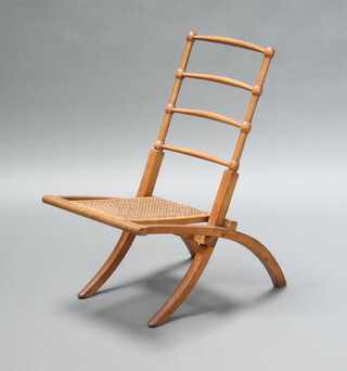 An Edwardian walnut ladderback folding chair with woven cane seat 69cm h x 38cm x 64cm