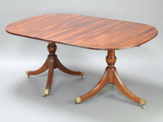 A mahogany Georgian style D end twin pillar extending dining table with two extra leaves 72cm h x 110cm w x 159cm l (short) or 276cm when extended with both leaves