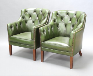 A pair of Georgian style club armchairs upholstered in green buttoned leather raised on square tapered supports, 84cm h x 67cm w x 57cm d (seats 31cm x 35cm)