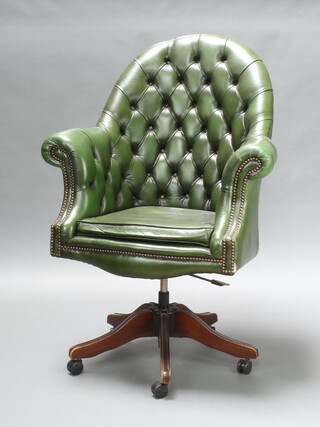 A Victorian style revolving armchair upholstered in green button back leather, 120cm h x 83cm w x 49cm d, inside seat 30cm x 34cm