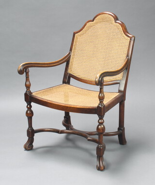 A 17th Century style beech open arm chair with cane seat and back, x frame stretcher and raised on scroll supports 97cm h x 62cm w x 53cm d, inside seat 40cm x 26cm