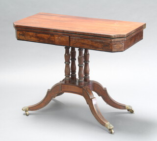 A Victorian inlaid mahogany card table raised on a turned column with shaped base and tripod supports 71cm h x 90cm w x 45cm d 