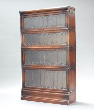 An oak 4 tier Globe Wernicke bookcase enclosed by lead glazed doors 146cm h x 86cm w x 31cm d 