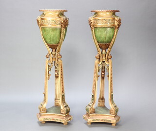 A pair of Adam style circular urns raised on outswept supports with triform base 122cm h x 30cm (PLEASE NOTE the height of the urns is 122cm not 21cm as shown in the printed catalogue)