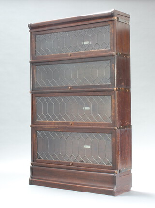 An oak 4 tier Globe Wernicke bookcase enclosed by lead glazed doors 140cm h x 86cm w x 26cm d 