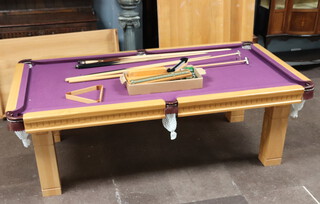 A light oak snooker/dining table raised on square supports, complete with 2 Star Exclusive cues, 2 BBL cues SD-1005, a Canon Chub cue, cue rack, triangle, score board, 2 rests, a set of billiard balls and a set of pool balls 79cm h x 243cm l x 137cm w 
