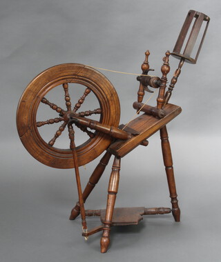 An 18th/19th Century elm and beech spinning wheel 93cm h x 68cm w x 41cm d 
