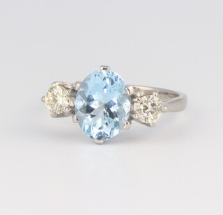 A white metal, stamped Plat, oval aquamarine and diamond ring, the centre stone 2.0cts and the brilliant cut diamonds 0.55ct, size N 1/2, 6.2gms