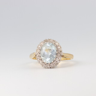 An 18ct yellow gold oval topaz and diamond cluster ring, size N, 4.6gms