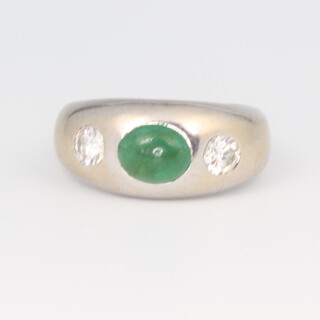 A white metal stamped 585 emerald and diamond gypsy set ring, the emerald approx. 1ct, the 2 brilliant cut diamonds approx. 0.5ct, size L, 7.9 grams 