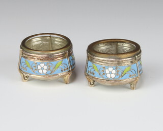 A pair of Russian silver and enamelled circular table salts stamped 910.MMET with blue, white and green enamelled band of scrolling flowers 4.5cm 