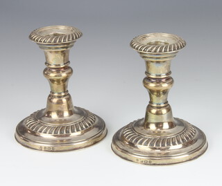 A pair of Edwardian silver dwarf candlesticks with waisted stems Birmingham 1906, maker J Sherwood and Sons, 11cm 
