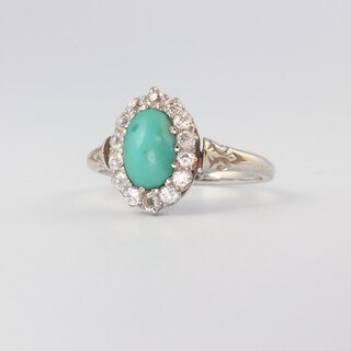 A white metal, stamped 18ct, oval turquoise and diamond cluster ring, the oval cabuchon centre stone chipped, surrounded by 14 brilliant cut diamonds, size J 1/2 , 3gms
