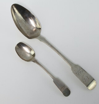 A William IV silver fiddle pattern dessert spoon with engraved monogram, Dublin 1834 together with a silver teaspoon, 86 grams 