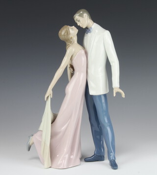 A Lladro group of a lady and gentleman in evening dress 6475, 30cm h