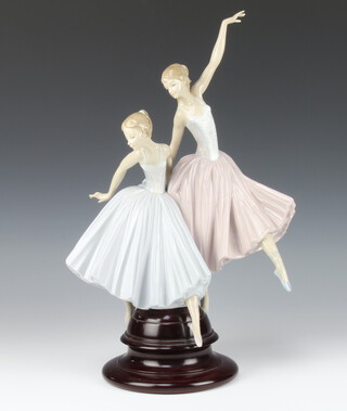 A Lladro group Merry Dancers on a circular wooden base, 47cm 