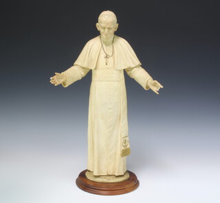 A composition figure of Pope John Paul II on a wooden base, 50cm h
