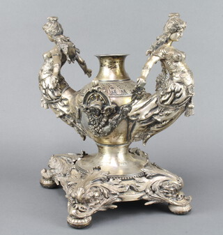 An impressive Victorian silver plated centrepiece, the 2 handles in the form of ladies raised on a quatrefoil base with dolphin feet 34cm 