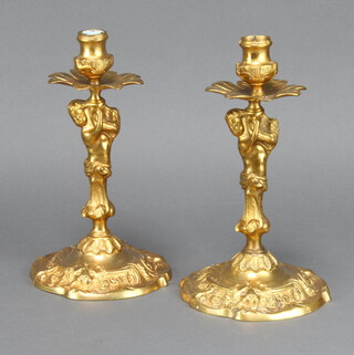 A handsome pair of 19th/20th Century gilt metal candlesticks supported by cherubs and with lion mask decoration to the bases 23cm h x 14cm (no sconces) 