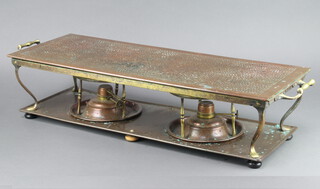 A rectangular copper and brass twin burner hot plate raised on bun feet 15cm h x 68cm w x 23cm d