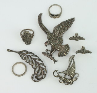 A silver and marcasite brooch in the form of an eagle carrying a fish and 2 other brooches, pair of ear clips and 3 rings  