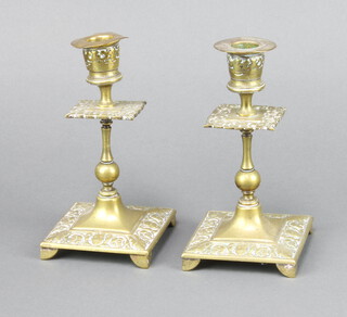 A pair of Victorian brass candlesticks raised on square bases 16cm h x 8cm w x 8cm d