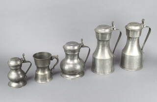 A pair of 19th Century waisted pewter lidded tankards, the bases with London touchmarks 24cm h x 13cm diam together with two other smaller lidded tankards and another tankard 13cm x 9cm diam