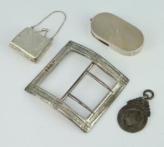 A Victorian silver buckle with bright cut decoration, a silver coin holder, fob and purse, gross weight 71 grams 