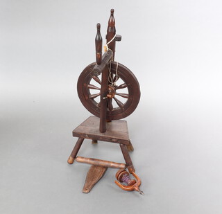 A 19th Century turned oak spinning wheel 89cm h x 31cm w x 20cm d 