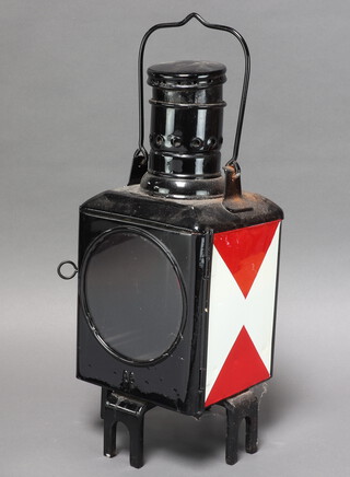 A black painted double sided railway lantern housing, the sides marked with a red and white triangle and impressed DB73 35cm h x 19cm w x 18cm d 
