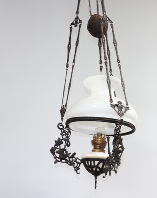 A Victorian hanging oil lamp with pottery reservoir and opaque shade contained within a metal frame 110cm h x 32cm diam. 