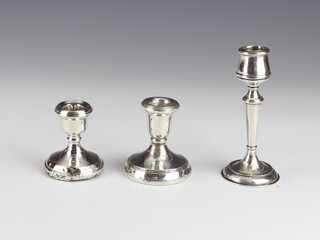 A stylish silver candlestick, Birmingham 1924 13cm, two dwarf ditto, rubbed marks