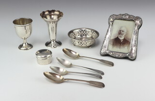 A silver pedestal cup, London 1948, four silver spoons, a bon bon dish and box, repousse photograph frame and plated vase, 150gms