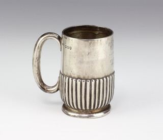 A Victorian silver demi fluted mug, London 1890 with presentation inscription, 9cm 126grams