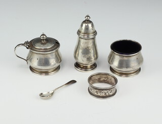 A silver three piece Queen Anne pattern condiment, Birmingham 1957, a spoon and a napkin ring, 116 gms