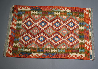 A white, green, red and turquoise Chobi Kilim rug with all over geometric design 124cm x 84cm 