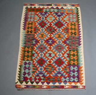 A green, orange, white and blue ground Chobi Kilim rug with all over geometric design 153cm x 100cm 